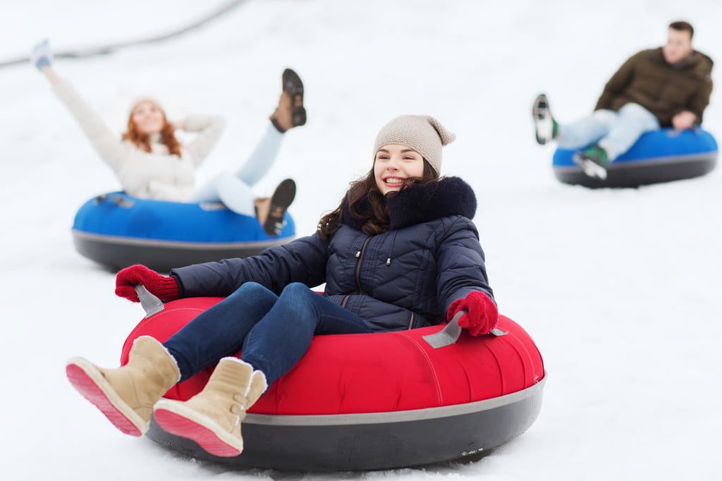 Girl sitting on a snow tube