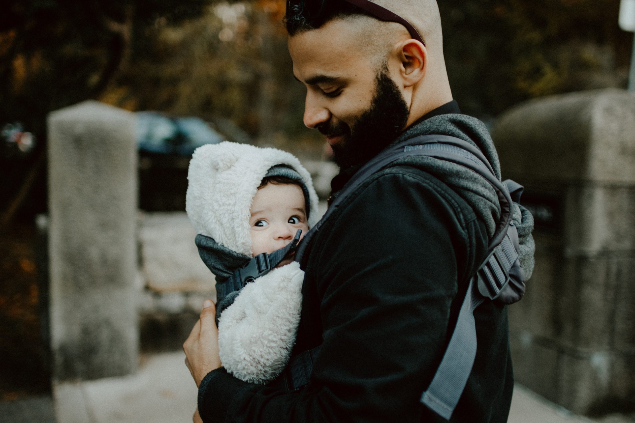 Dad holding baby with carrier