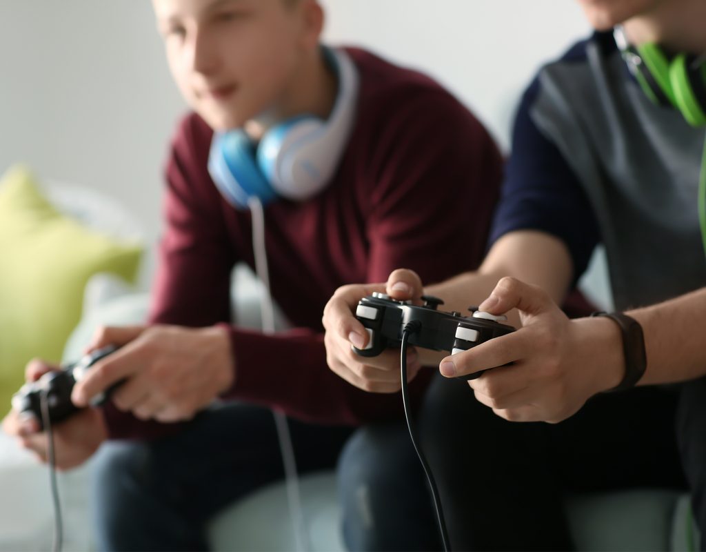 Teens having fun playing video games