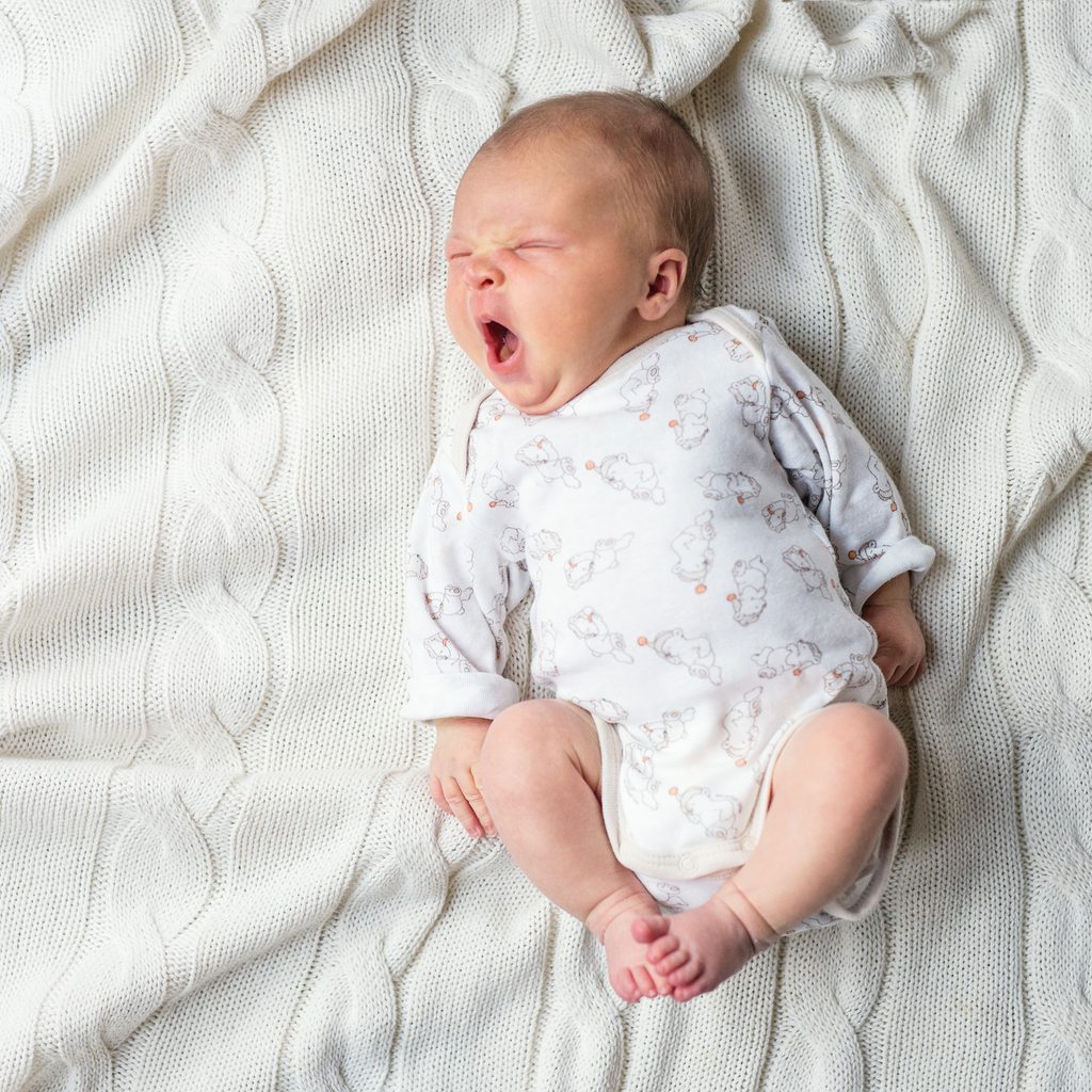 Tired baby yawning.