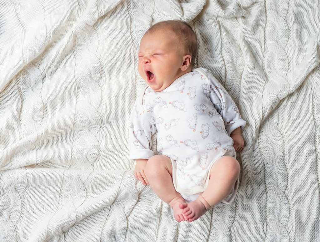 tired baby yawning