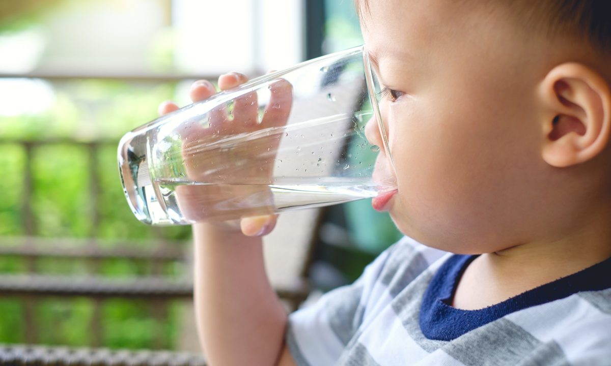 Toddler drinking glass of water