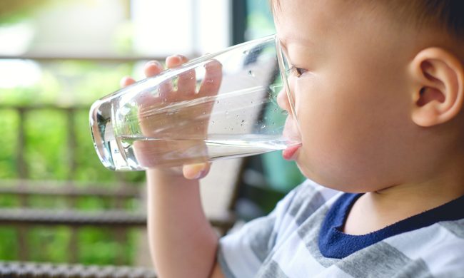 Toddler drinking glass of water