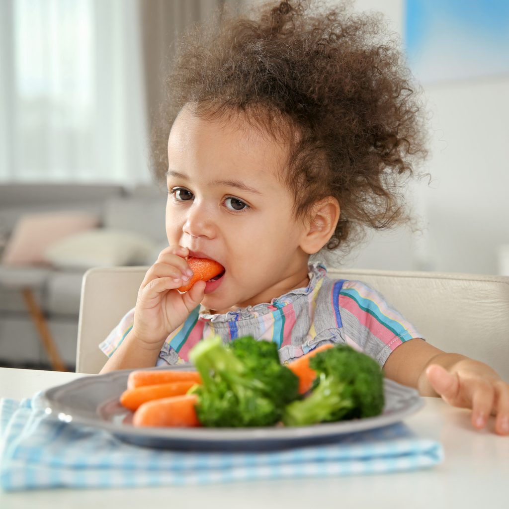 toddler eating vegetables