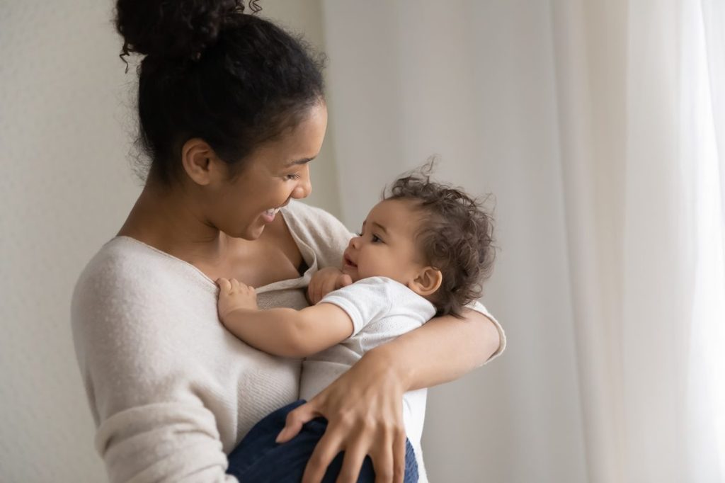 A mother holding her baby.