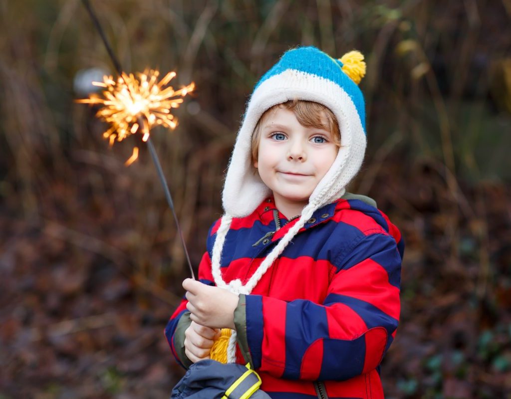 Toddler boy holds a sparkler