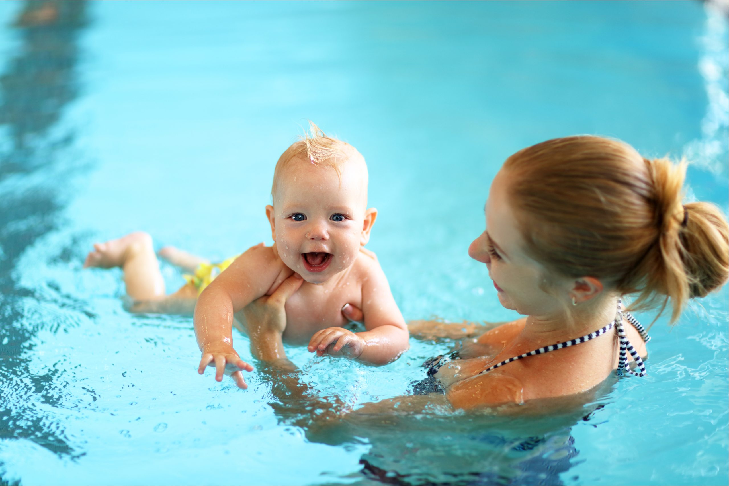Mom teaching baby to swim