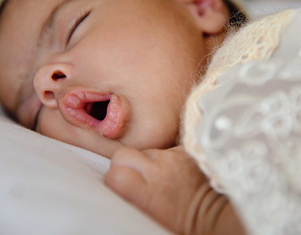 Baby girl sleeping in a bed