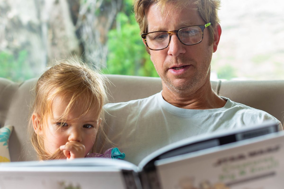 Daddy and daughter reading book
