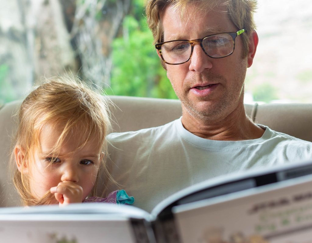 Dad and daughter reading book