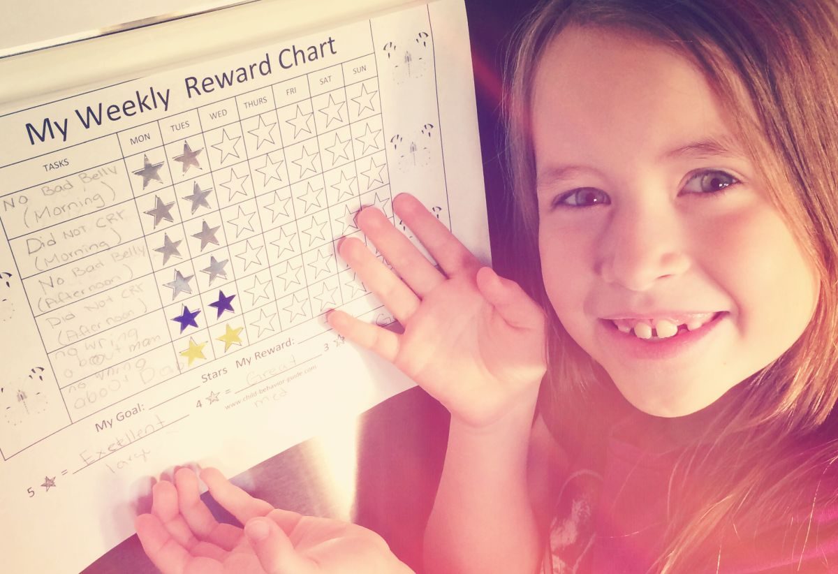 A smiling girl With A chore chart