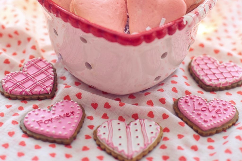 Valentine's Day cookies on a table with a bowl