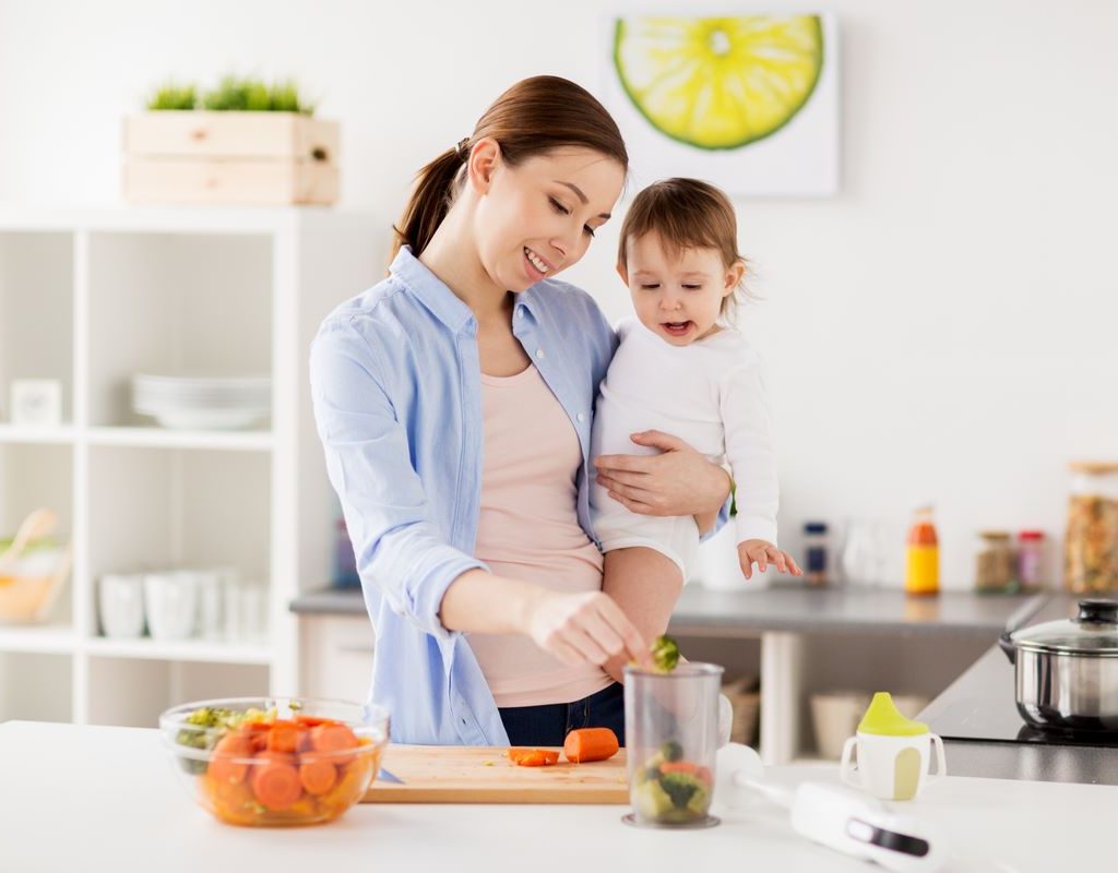 A mom prepares a meal for her baby