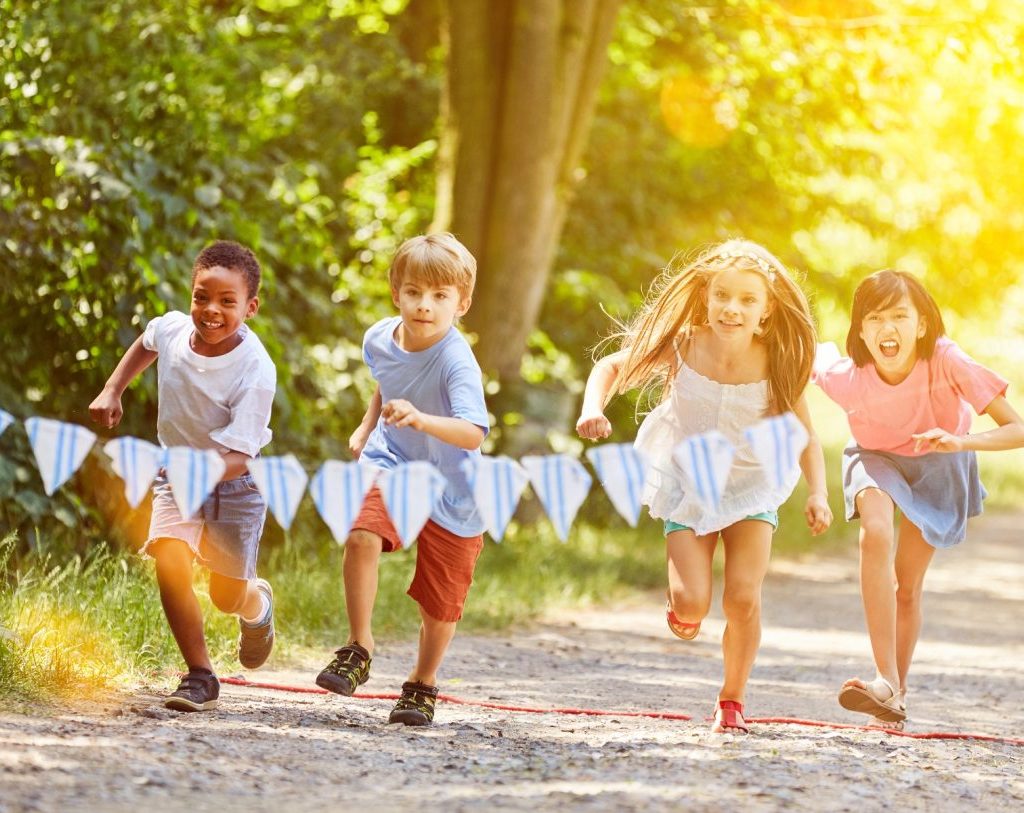 Kids running with each other at a party