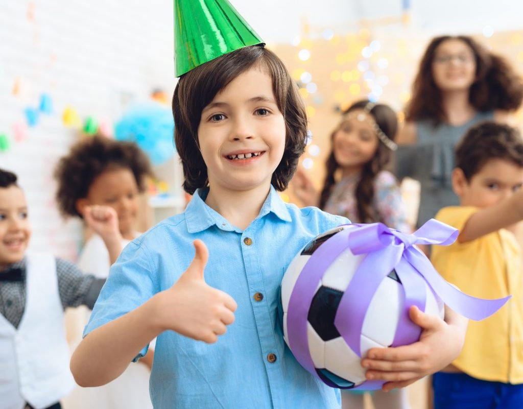 A child getting a soccer ball for their birthday.