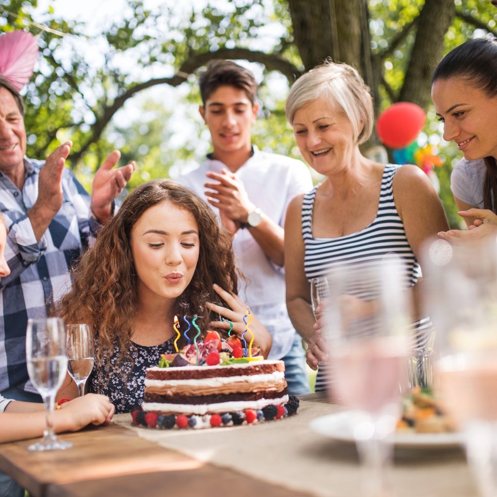 Teenage girl and her family celebrating her birthday