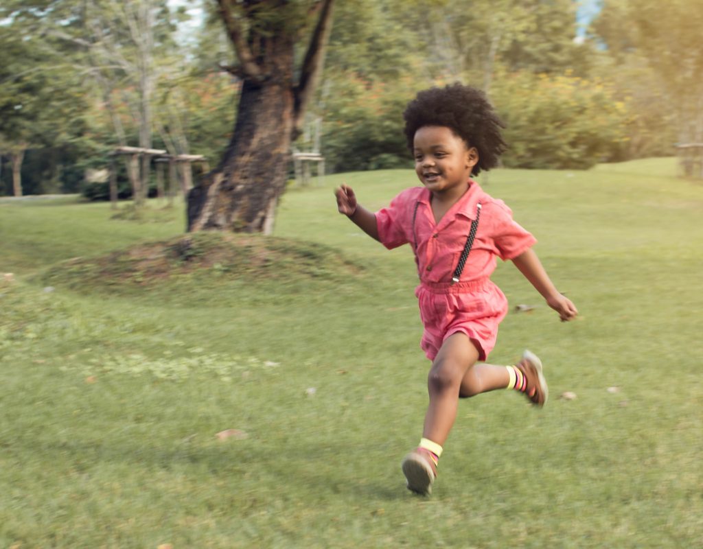 Toddler boy running in the park