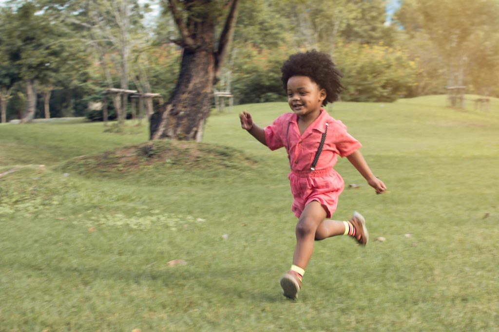 Toddler boy running in the park
