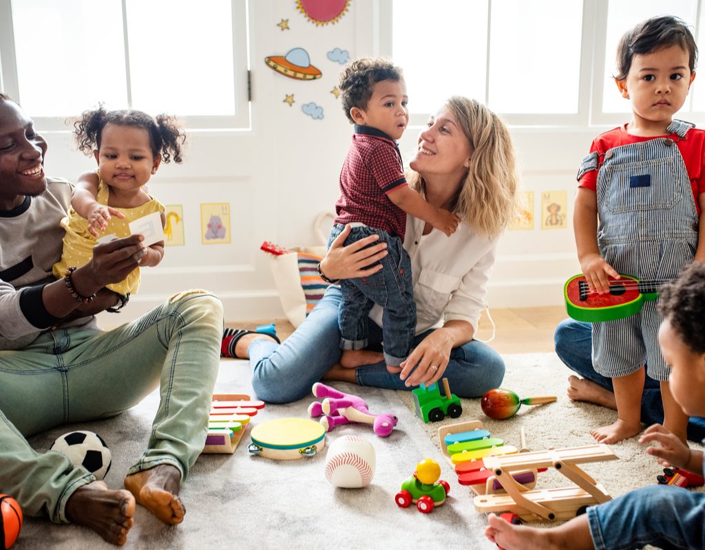 Toddlers having fun in a playgroup with parents