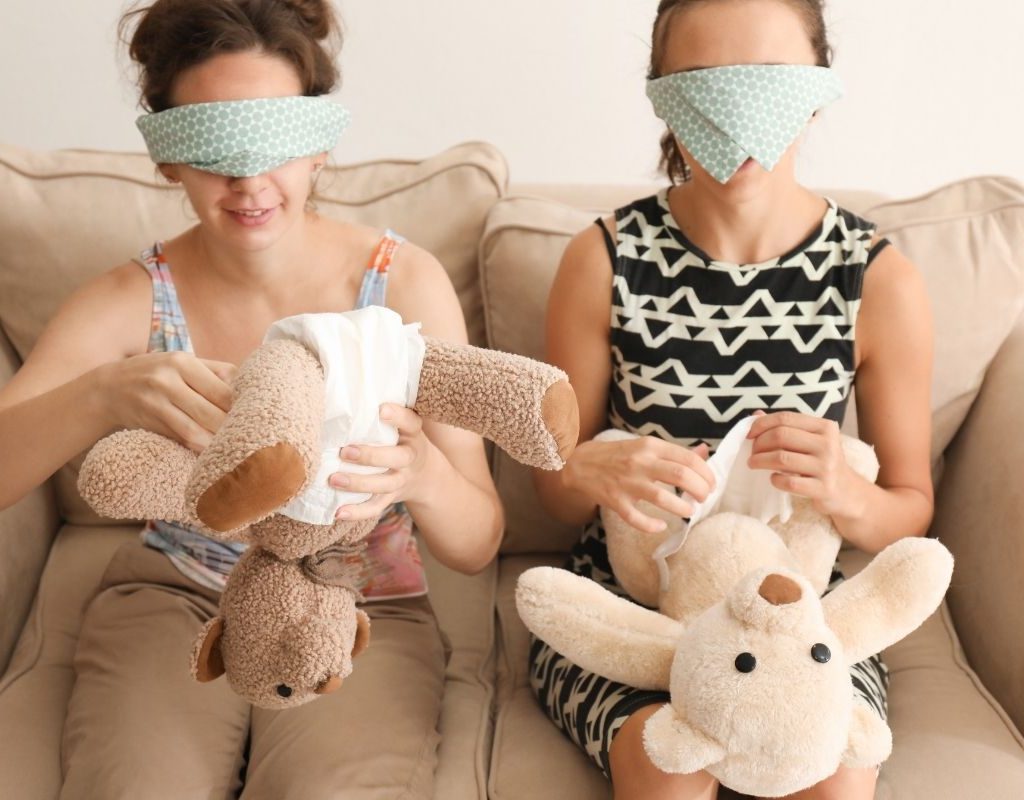 Two women playing a game at a baby shower
