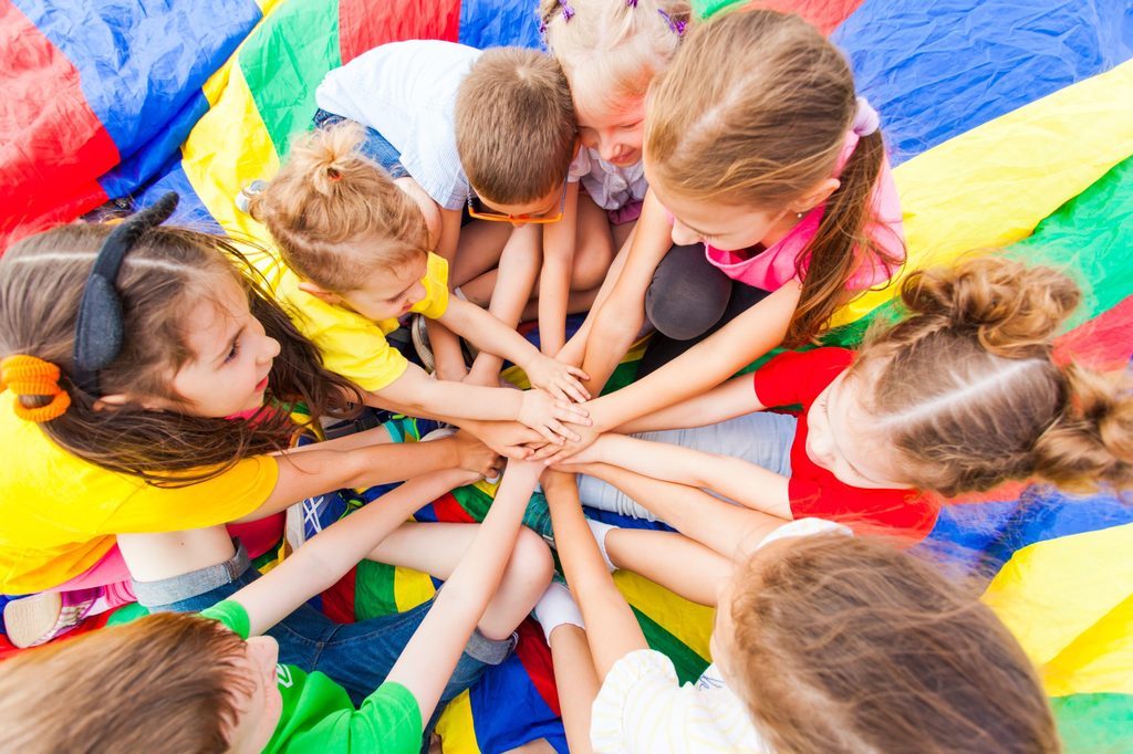Group of kids playing together joining hands