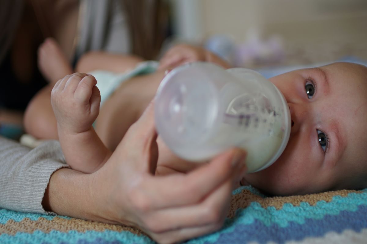 Baby drinking from a bottle.