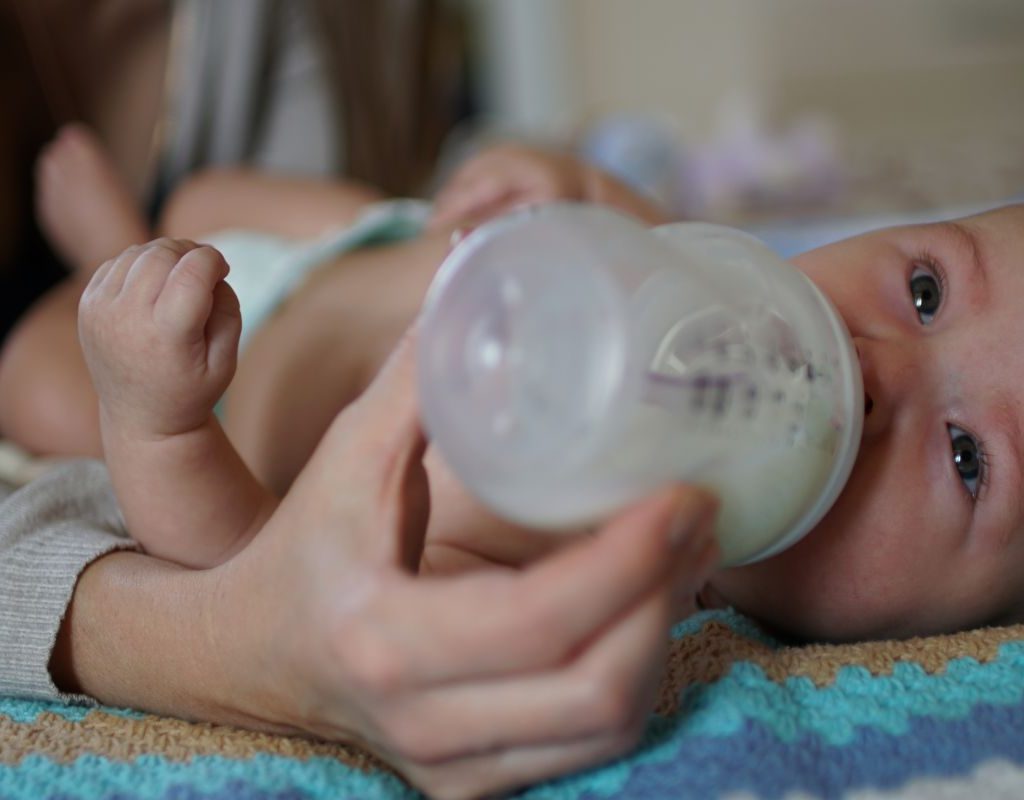 Baby drinking from a bottle.