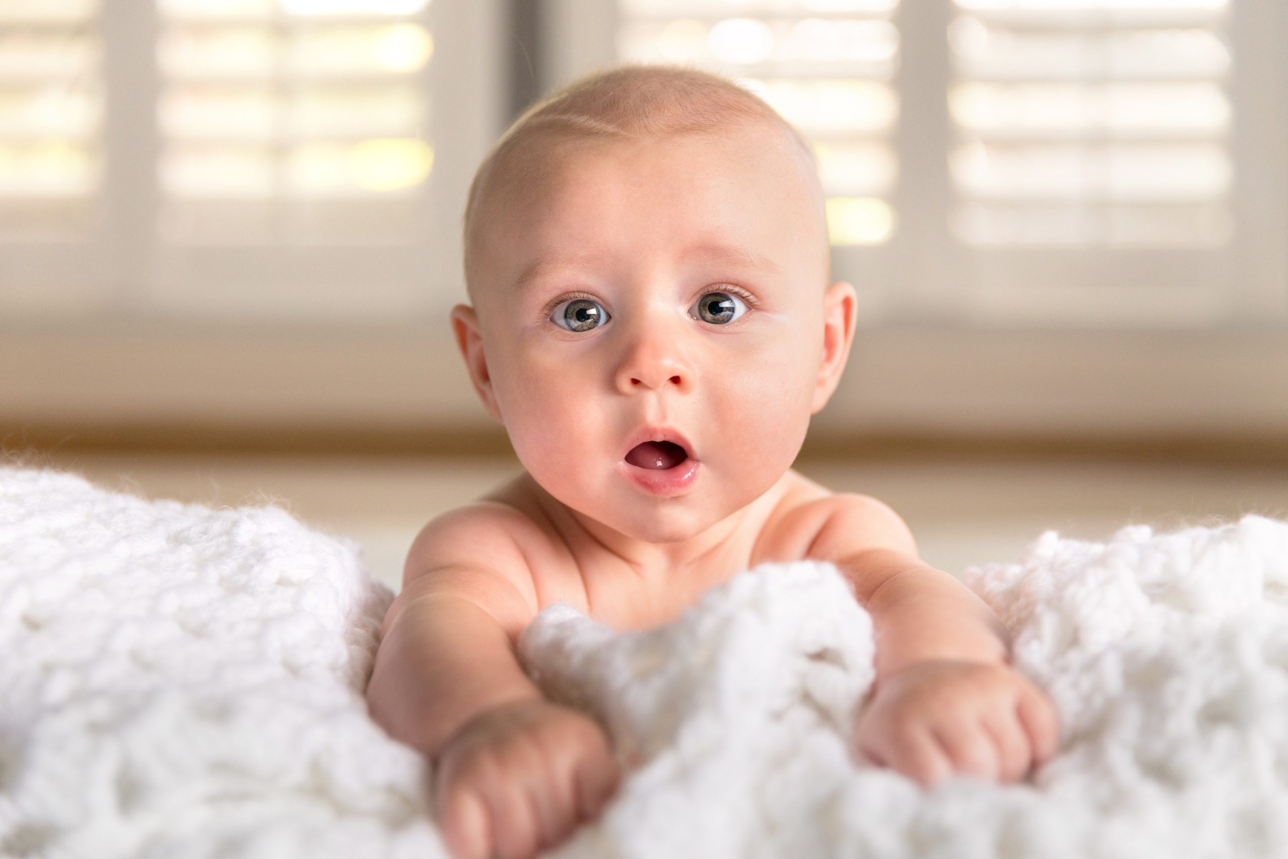 Baby in a bed with a blanket