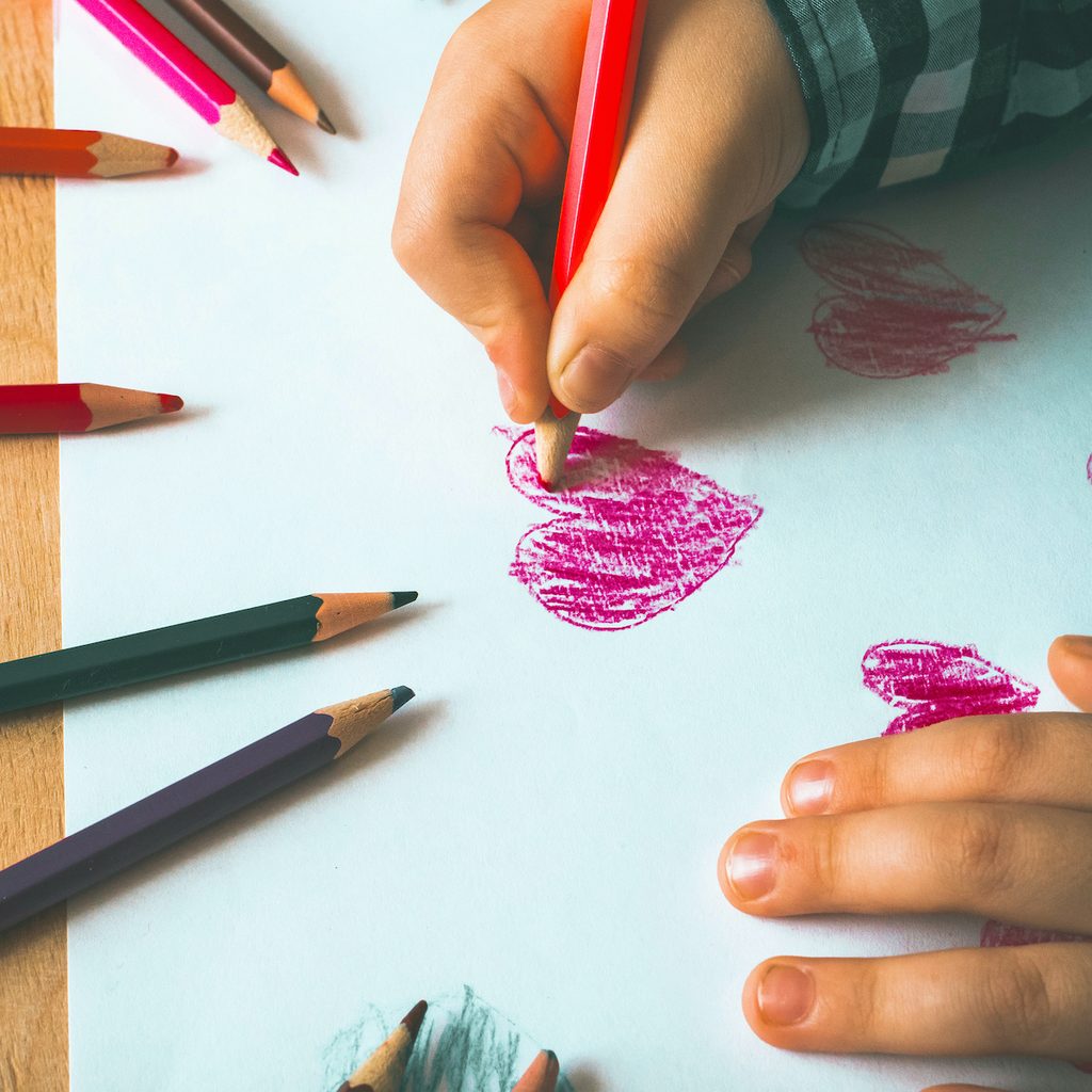 A child drawing a heart