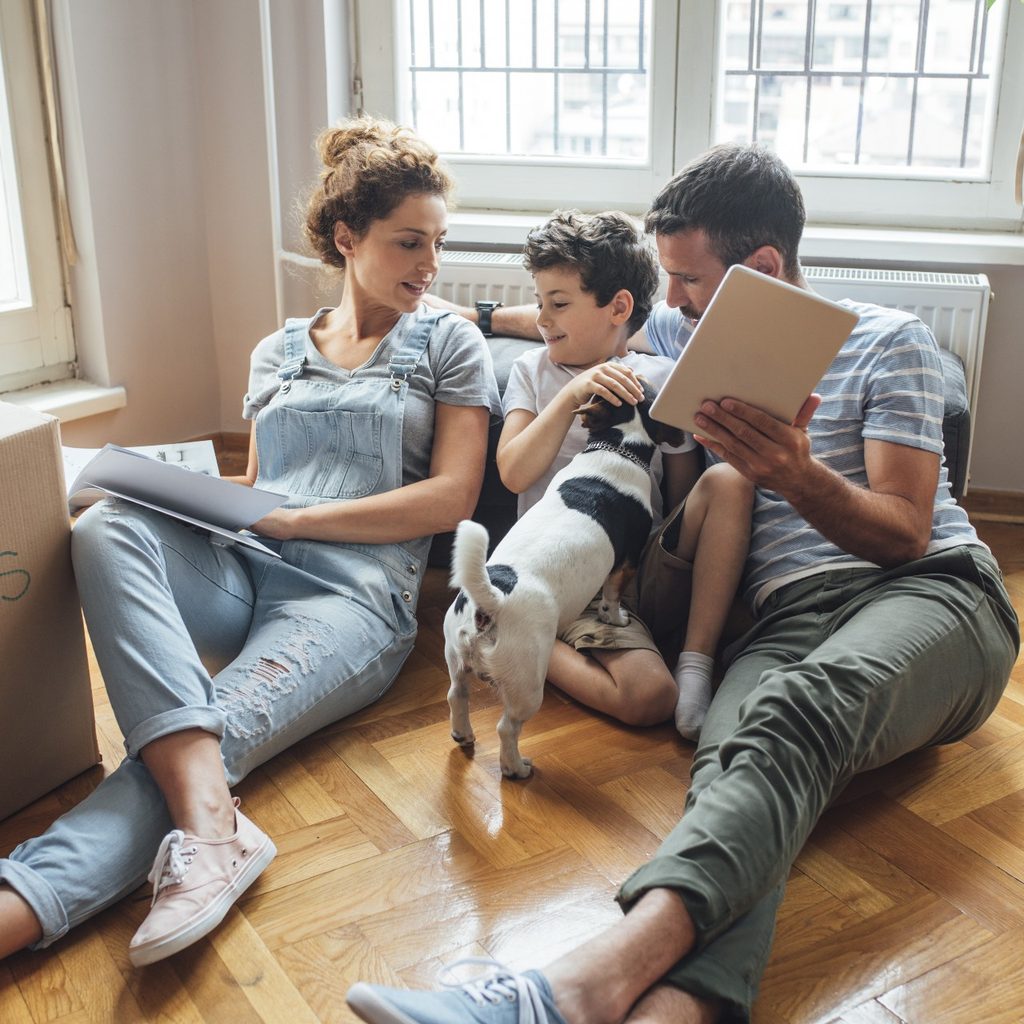 Family sitting on the floor, planning their move