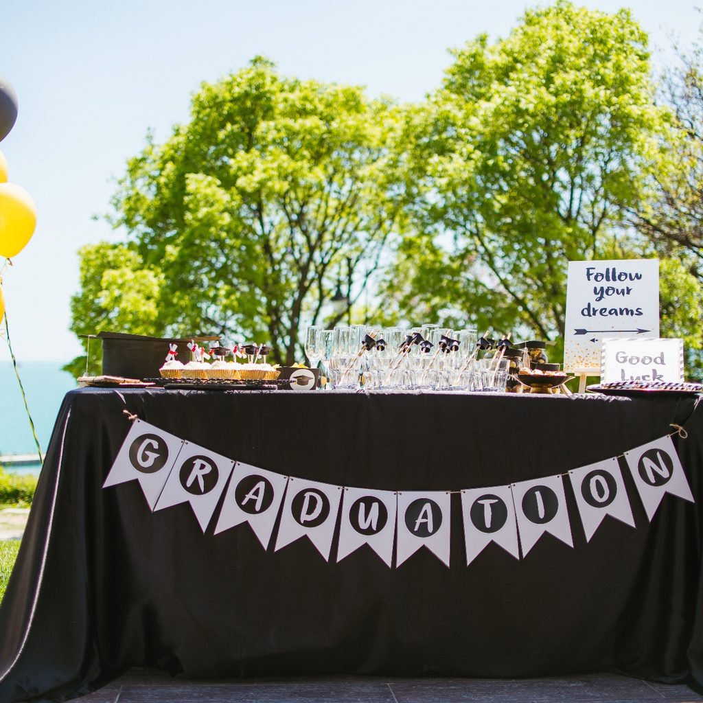 Table set up outside welcoming guests to outdoor graduation party