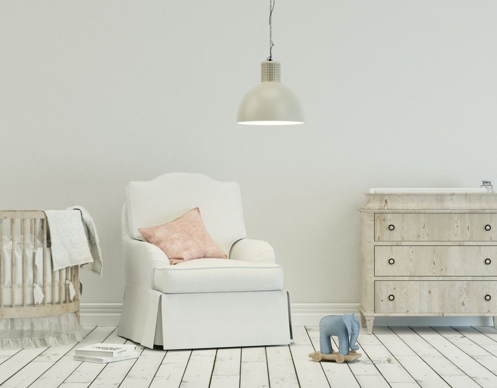 A glider chair and dresser in a nursery