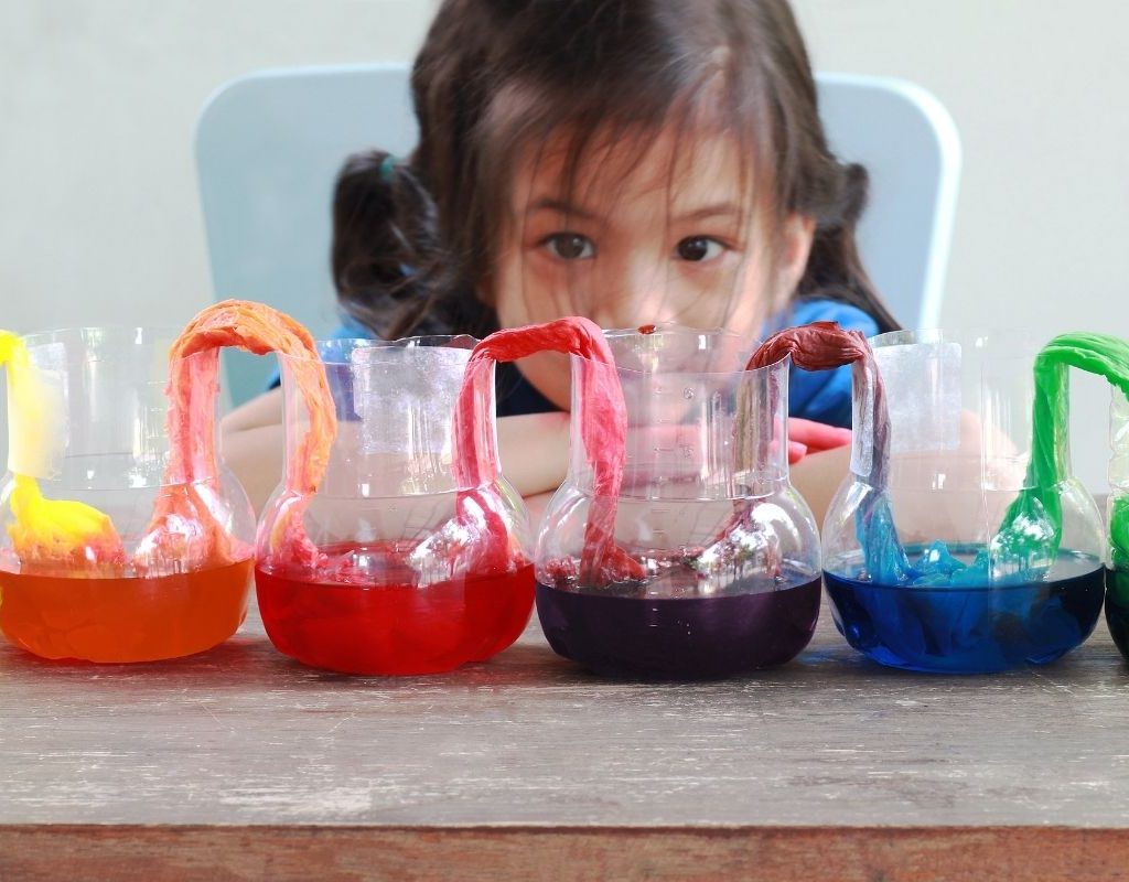Girl conducting a kids' science experiment at home.