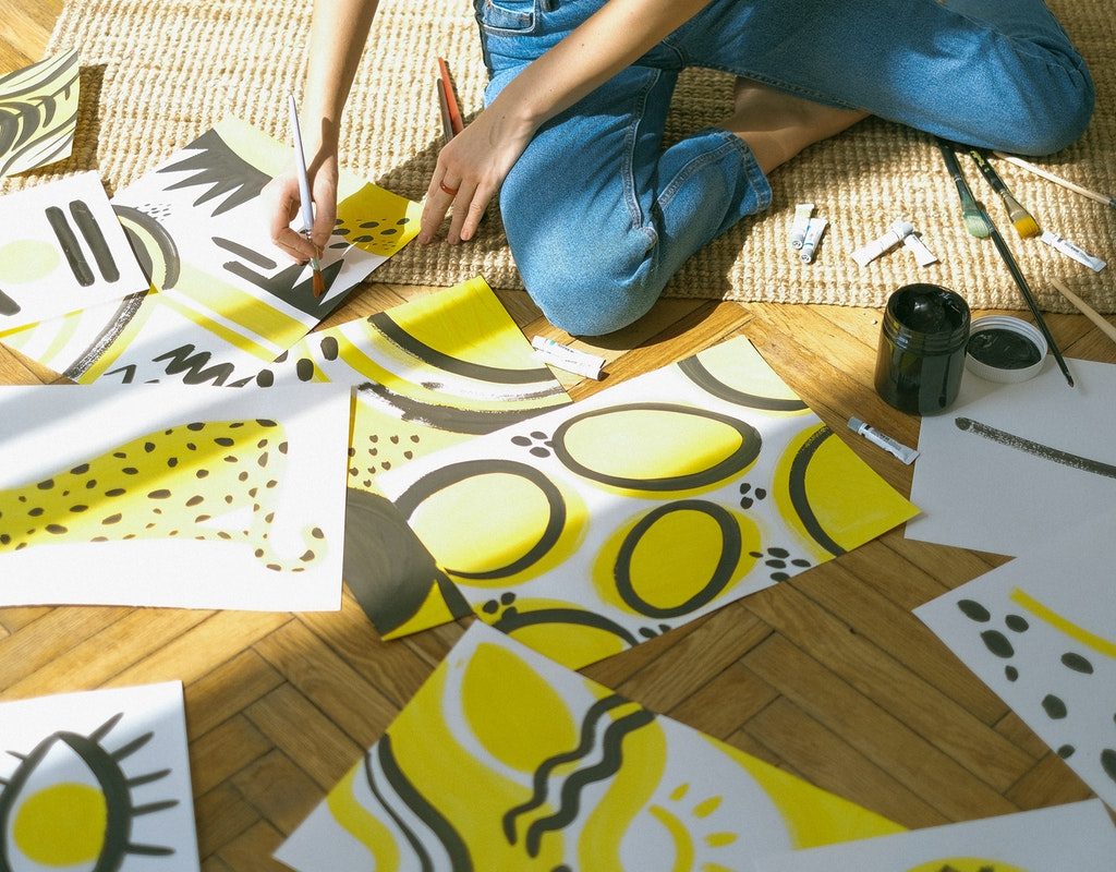 teen girl painting pictures on the floor