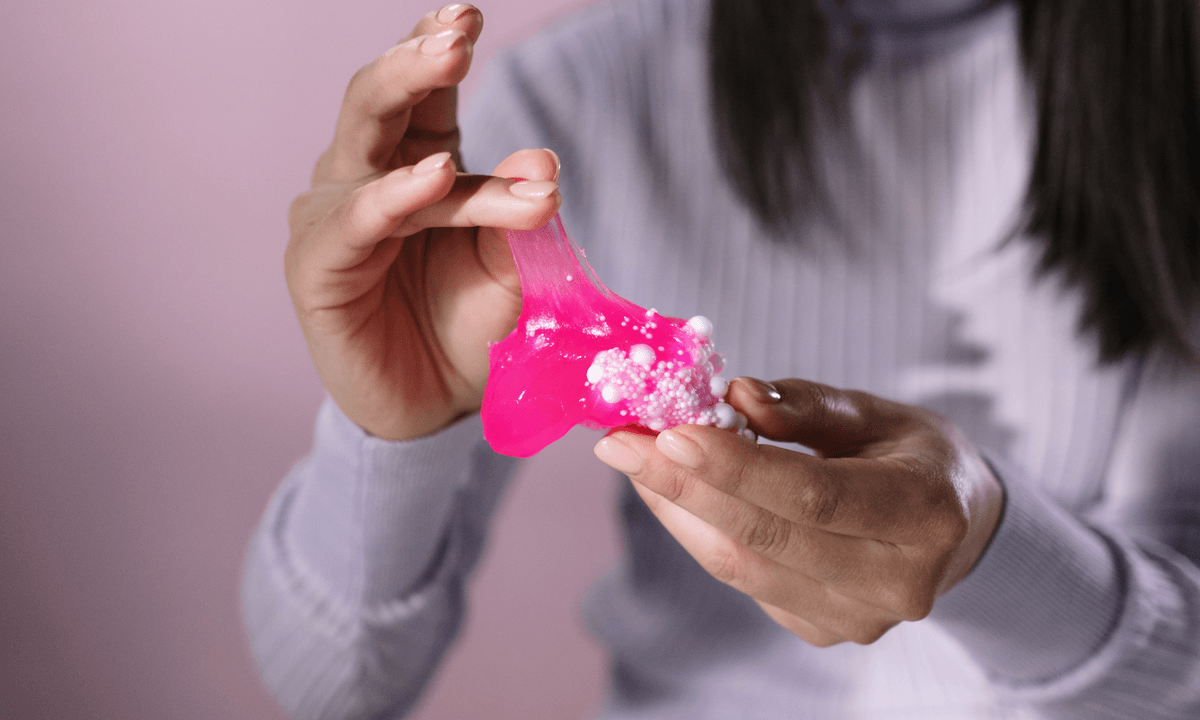 Woman with slime between fingers