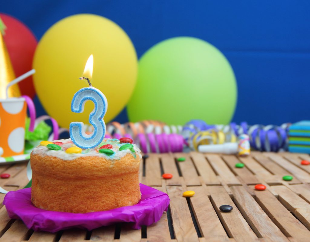 Birthday cake with a number 3 candle on it
