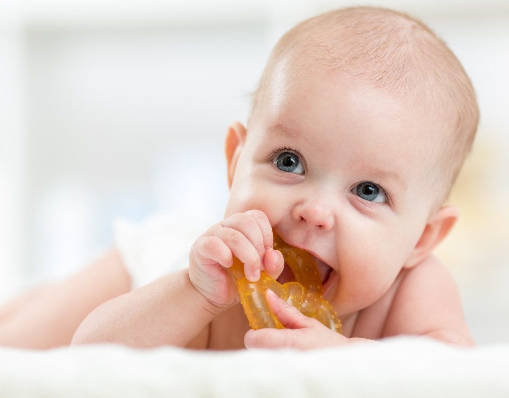 Baby with teething toy