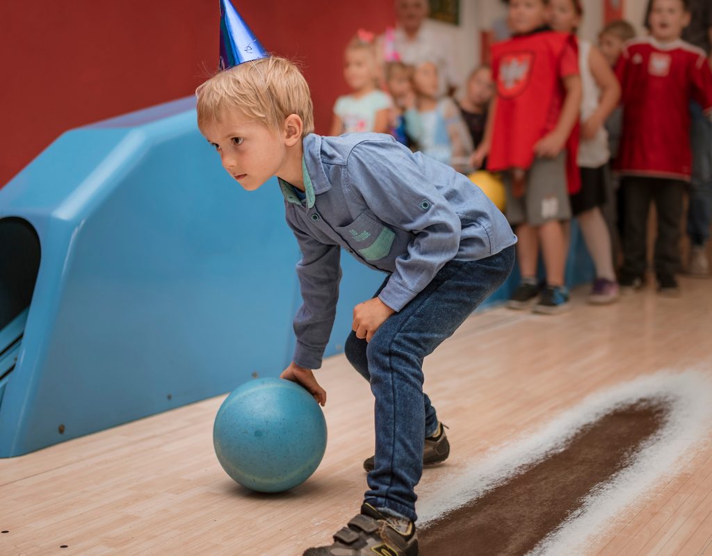 Child bowling at a bowling alley birthday party