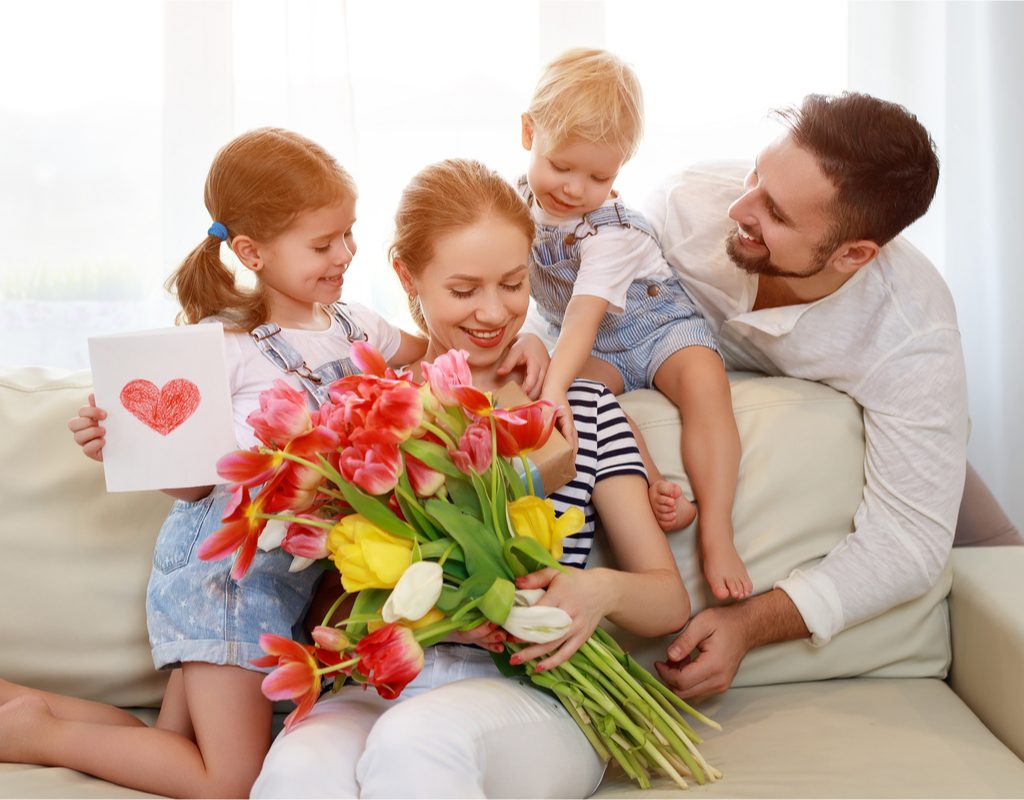 Family giving their mom flowers