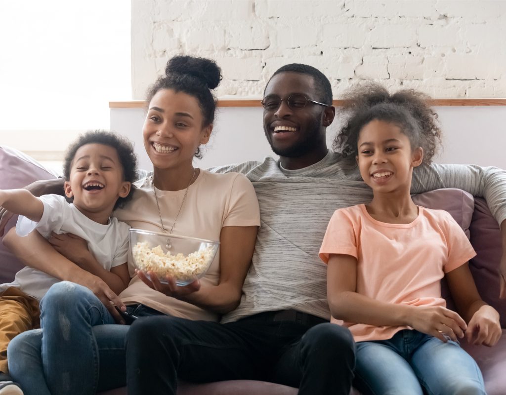 Family on couch watching TV