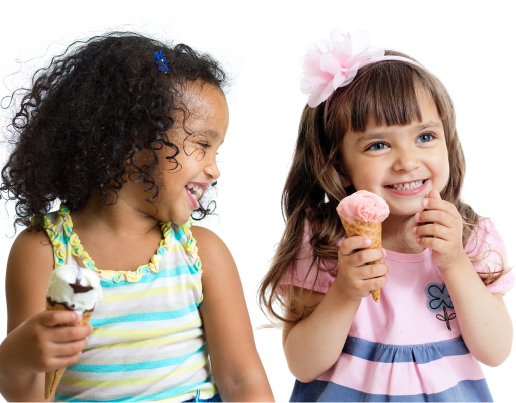 Two happy girls holding ice cream cones