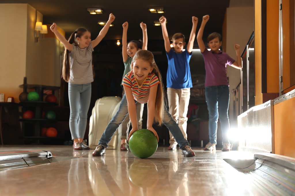 Kids having fun at a bowling alley party