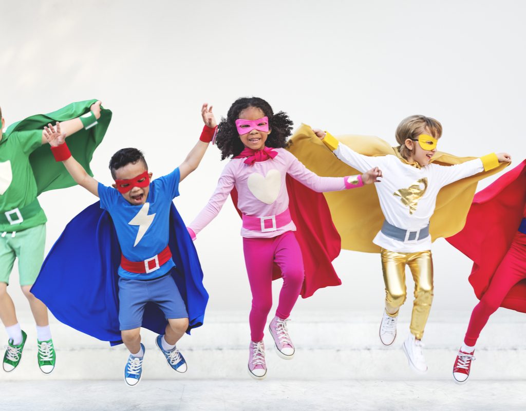 A group of kids dressed in superhero costumes