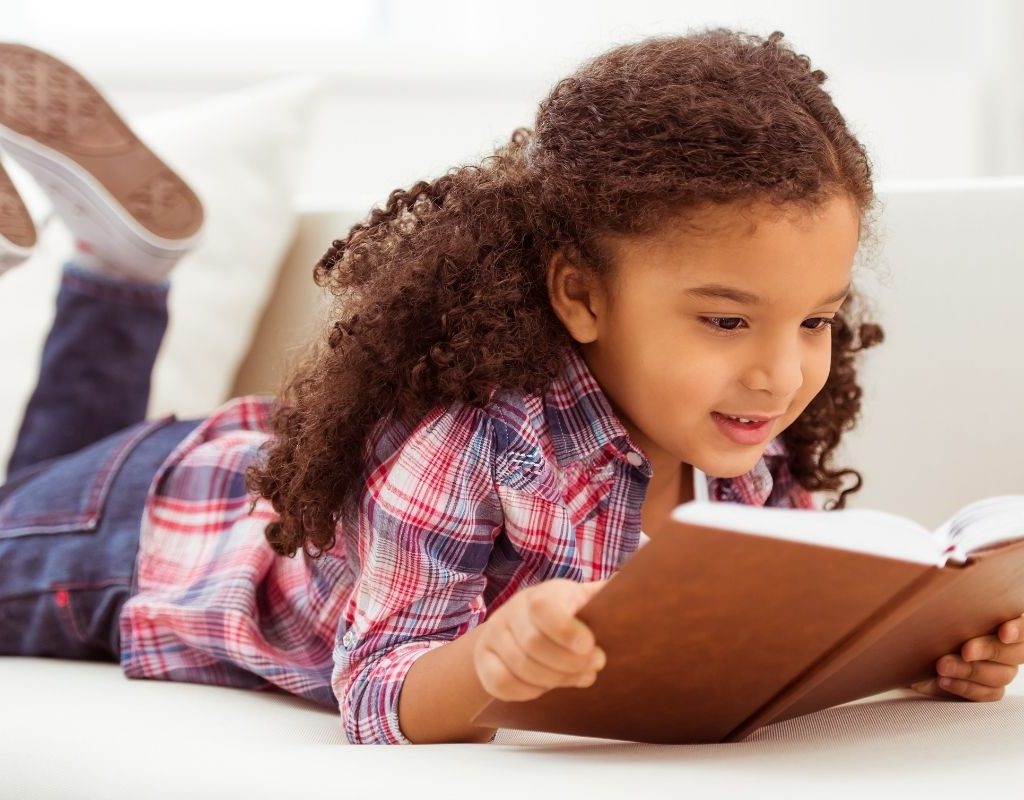Little girl reading a book
