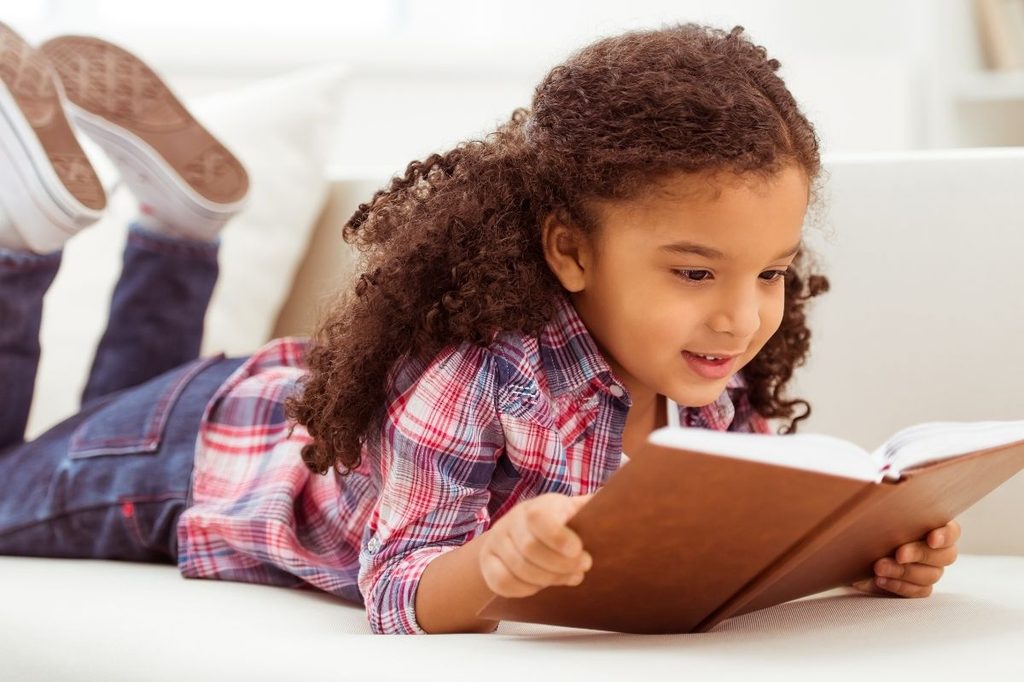 Little girl reading a book
