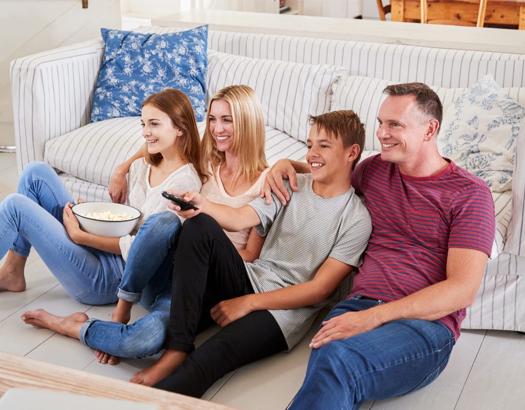 Parents watching TV with teens