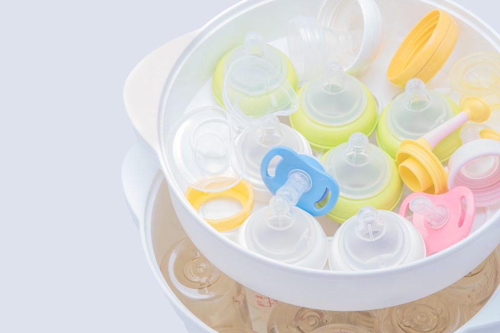 A plastic bowl of sanitized pacifiers.