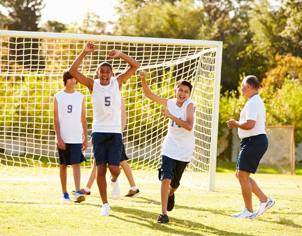 Teens playing soccer