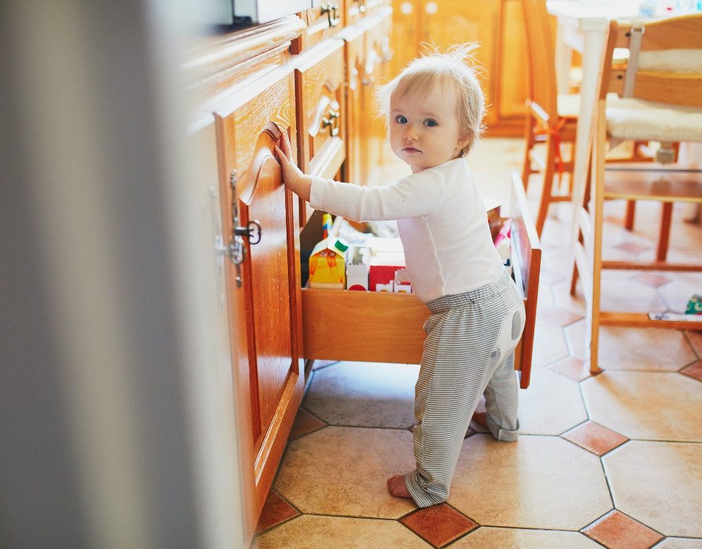 baby going through drawers in kitchen