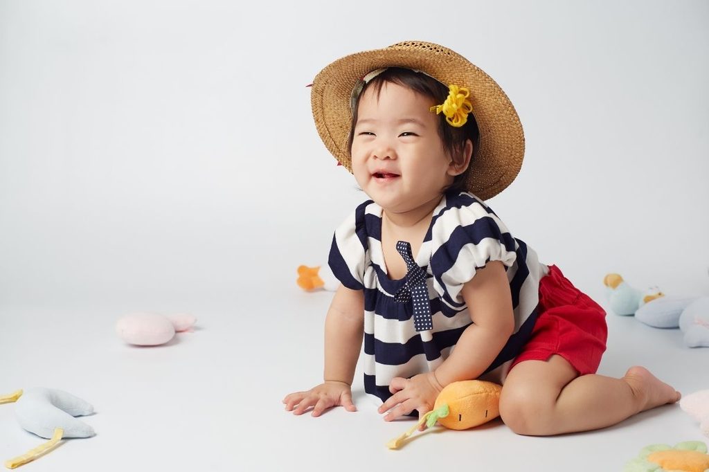 A baby in summer clothing.